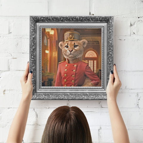 Silver framed artwork of a Cheetah in regal attire being hung on wall by a person