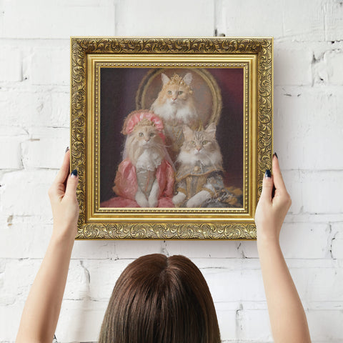Gold framed artwork of cats in regal attire being hung on wall by a person