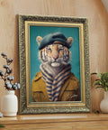 Framed artwork of a tiger wearing a coat and beret in a gold frame on a wooden surface