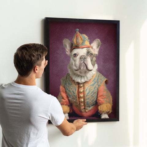 Dog portrait art featuring a French bulldog in a jester outfit being hung on wall in black A2 frame, vintage animal decor for UK home