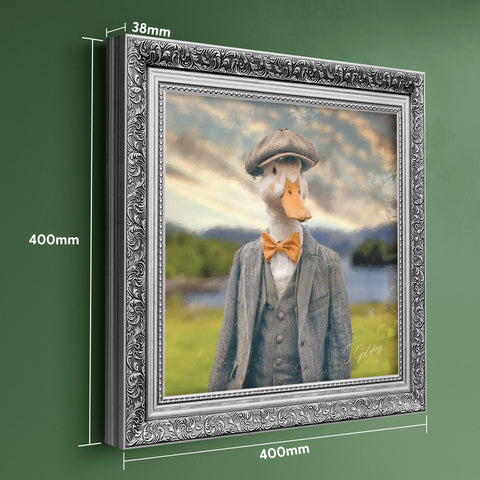 Framed artwork of a duck wearing a suit with scenic background, displayed in a silver baroque frame, showing product dimensions
