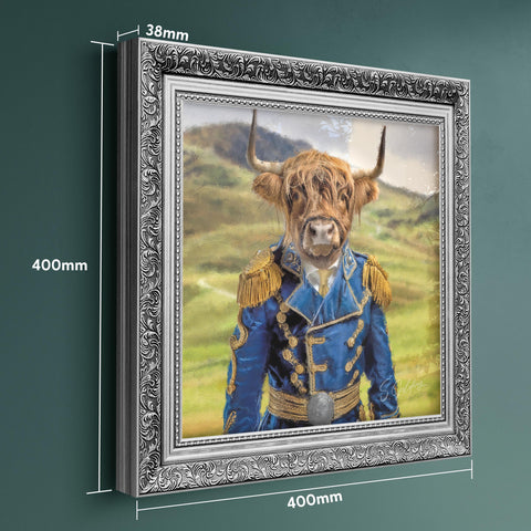 Highland cow portrait wall art featuring a Scottish Highland cow in blue matador uniform with ornate silver frame, displaying frame dimensions