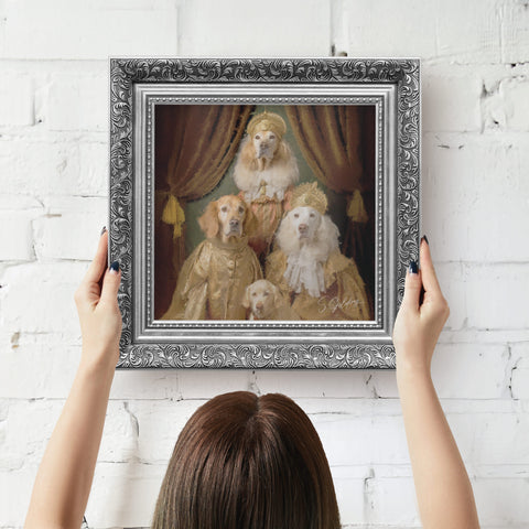 Silver framed artwork of dogs in regal attire being hung on wall by a person