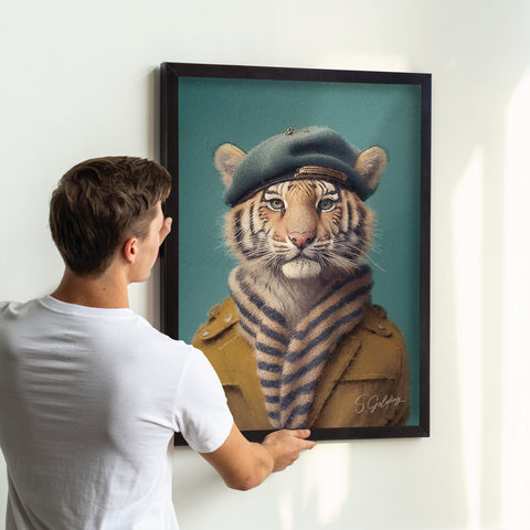 Tiger wall art wearing a coat and beret in a black A2 frame being hung on wall in uk home